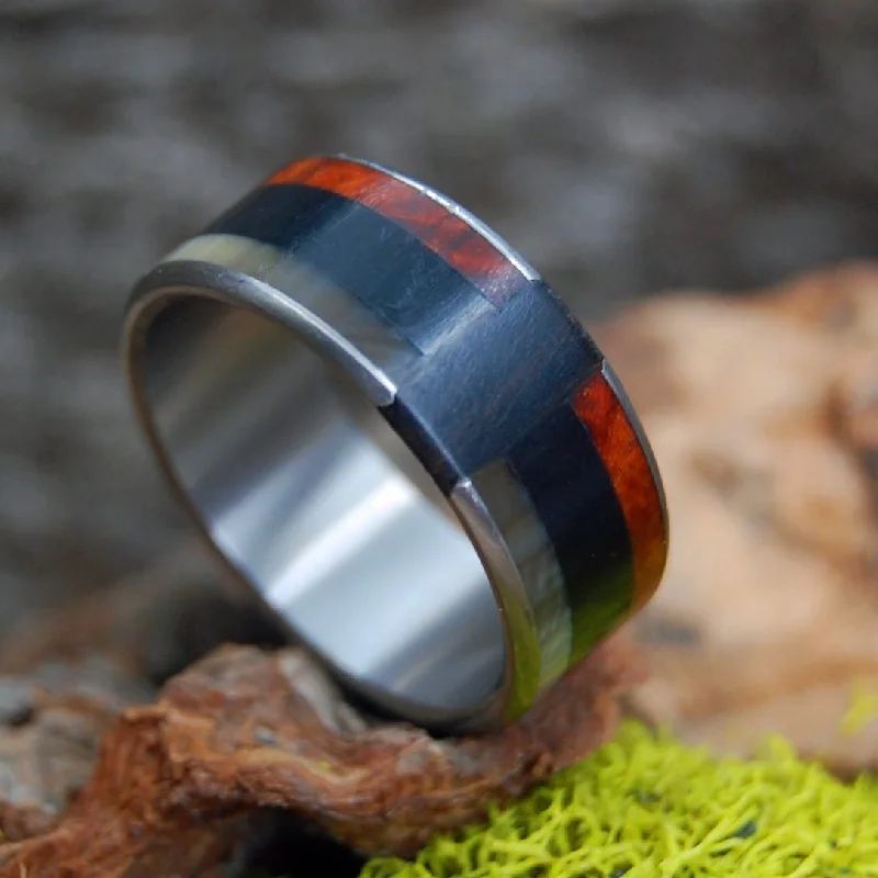 Rings featuring hematite for dark gemstone finger glow -Love Never Fails | Men's Sheep Horn, Onyx Stone, Red Oak Wood & Titanium Wedding Ring