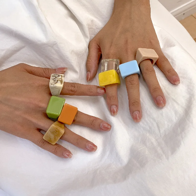 Rings featuring flexible bands for comfy finger fit -Wholesale Flow Colored Candy Colored Acrylic Geometric Rings