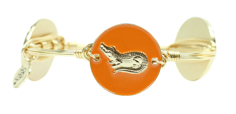 Unique twisted metal bangles with intricate details for a sophisticated, modern style -The Orange Alligator Bangle Bracelet