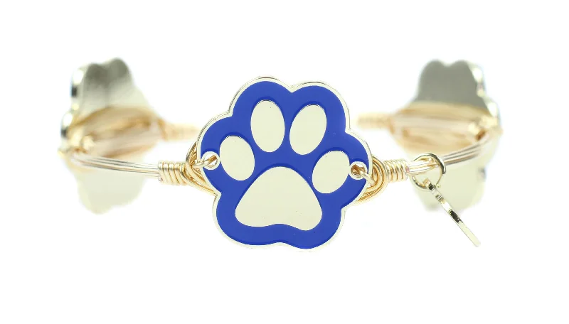 Classic chain-link bracelets for women who love timeless, versatile jewelry choices -The Blue + Gold Paw Print Bangle Bracelet